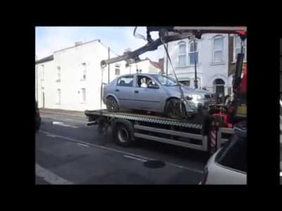 Badly parked car taken to a town truck... and reaction of th